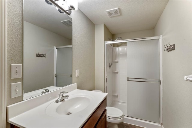 14037 W 112th Ter, Olathe, KS 66062 - bathroom featuring toilet, a shower stall, a textured ceiling, vanity, and a textured wall