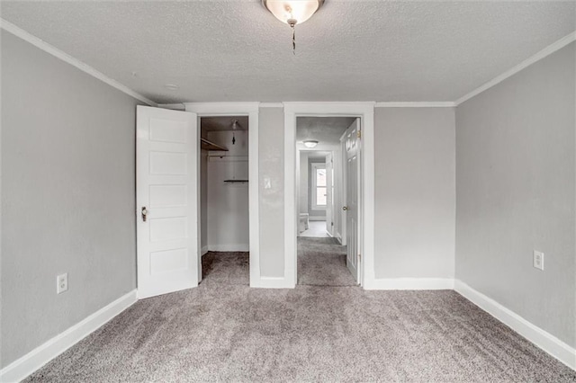 628 S Huttig Ave, Independence, MO 64053 - unfurnished bedroom with a textured ceiling, carpet, baseboards, a closet, and ornamental molding