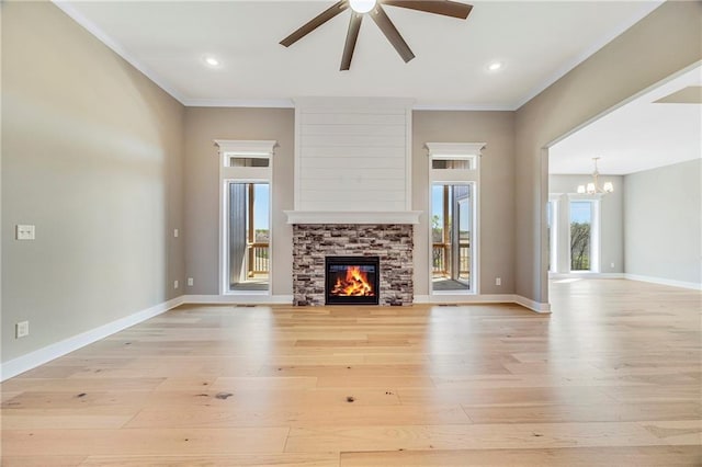 10201 N Winchester Ave, Kansas City, MO 64156 - unfurnished living room featuring ceiling fan, light wood-style floors, ornamental molding, a chandelier, and a stone fireplace