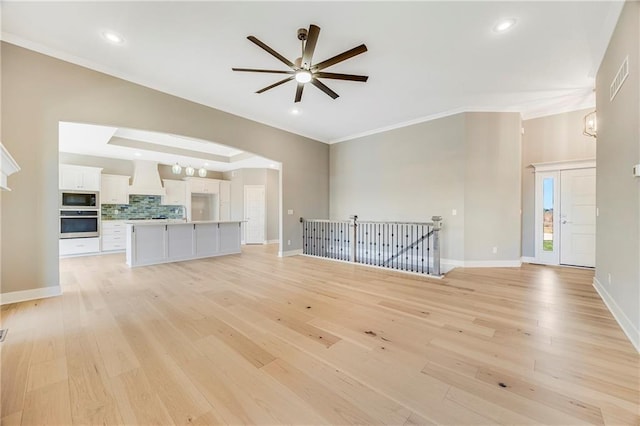 10201 N Winchester Ave, Kansas City, MO 64156 - unfurnished living room with a ceiling fan, light wood-style floors, baseboards, ornamental molding, and recessed lighting