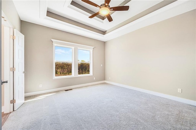 10201 N Winchester Ave, Kansas City, MO 64156 - carpeted empty room featuring ceiling fan, a raised ceiling, and baseboards