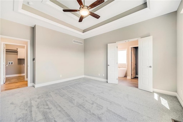 10201 N Winchester Ave, Kansas City, MO 64156 - unfurnished bedroom featuring carpet flooring, a raised ceiling, and baseboards