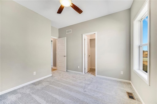 10201 N Winchester Ave, Kansas City, MO 64156 - unfurnished bedroom featuring light colored carpet, a spacious closet, baseboards, and ceiling fan