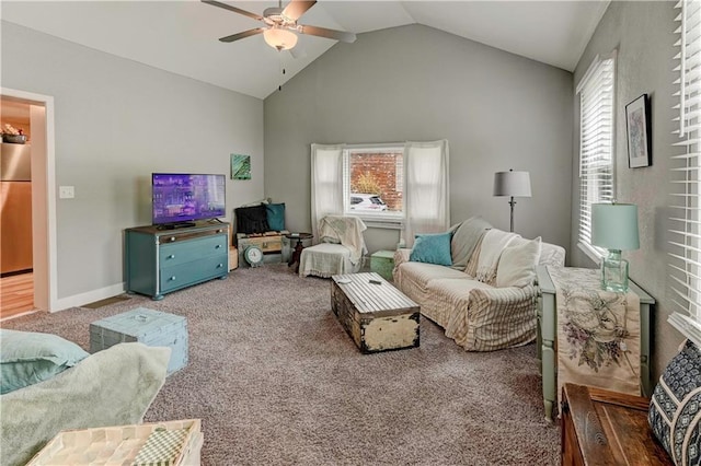 carpeted living area featuring ceiling fan, vaulted ceiling, and baseboards