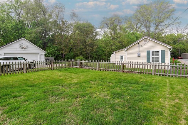 view of yard with a garage, an outbuilding, and view of scattered trees