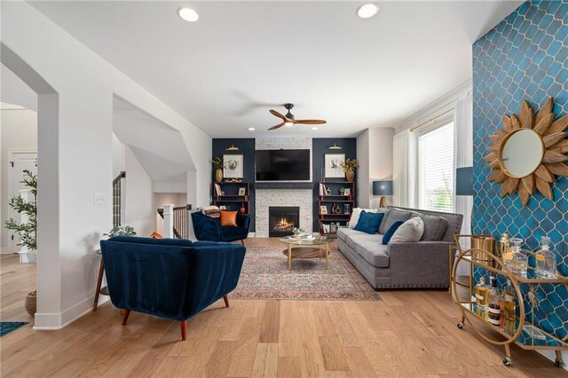 18873 W 168th Ter, Olathe, KS 66062 - living area featuring an accent wall, ceiling fan, light wood-type flooring, a fireplace, and recessed lighting