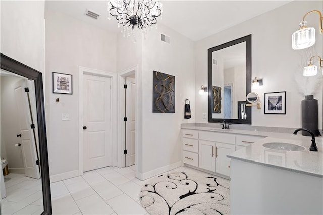 18873 W 168th Ter, Olathe, KS 66062 - bathroom with a chandelier, baseboards, double vanity, tile patterned flooring, and toilet