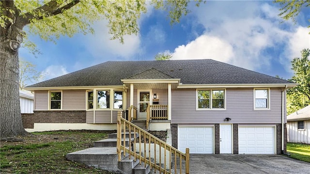 view of front of house featuring a garage, concrete driveway, brick siding, and a shingled roof