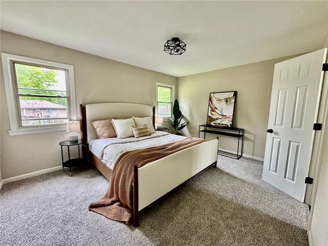 bedroom featuring carpet and baseboards