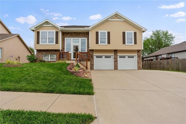 split foyer home featuring brick siding, concrete driveway, and an attached garage