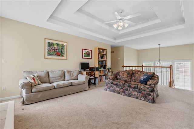 living room featuring carpet flooring, a ceiling fan, and a tray ceiling