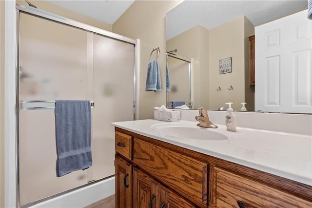 bathroom featuring a shower stall, vanity, and tile patterned flooring