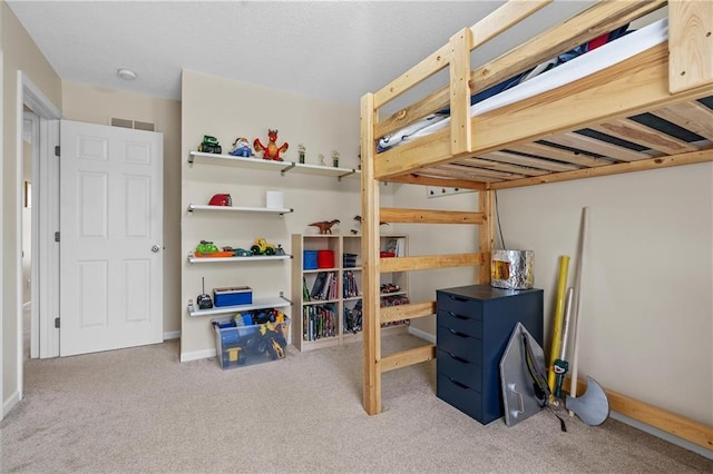 carpeted bedroom with baseboards