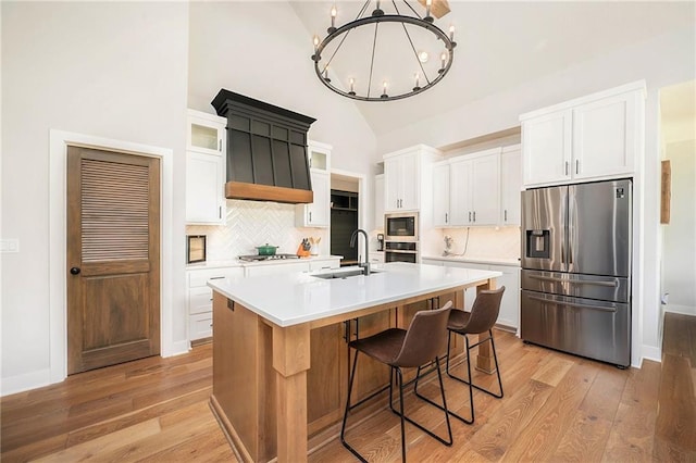 1309 NW 107th Ter, Kansas City, MO 64155 - kitchen with appliances with stainless steel finishes, a sink, light wood finished floors, tasteful backsplash, and high vaulted ceiling