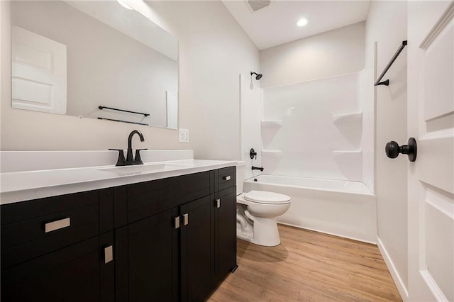 1309 NW 107th Ter, Kansas City, MO 64155 - full bath featuring wood finished floors, toilet, vanity, and washtub / shower combination