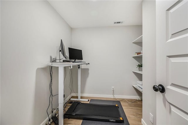 1309 NW 107th Ter, Kansas City, MO 64155 - exercise room with baseboards and wood finished floors