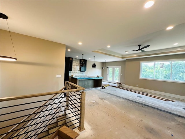 202 E Maple St, Lone Jack, MO 64070 - kitchen with recessed lighting, a tray ceiling, a center island, pendant lighting, and a ceiling fan