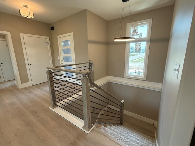 202 E Maple St, Lone Jack, MO 64070 - stairs with wood finished floors and baseboards