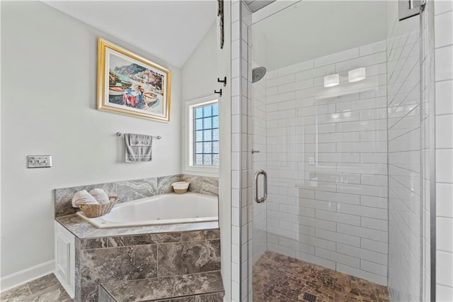 31560 W 85th St, De Soto, KS 66018 - bathroom featuring lofted ceiling, a shower stall, a bath, and baseboards