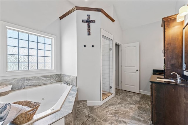 31560 W 85th St, De Soto, KS 66018 - full bathroom featuring vaulted ceiling, a whirlpool tub, vanity, a shower stall, and baseboards
