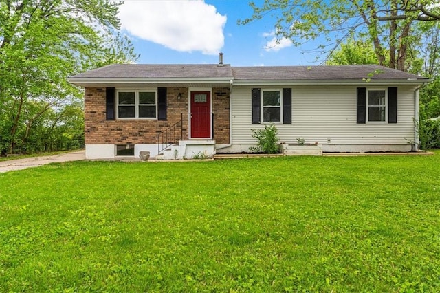 ranch-style house with a front yard and brick siding
