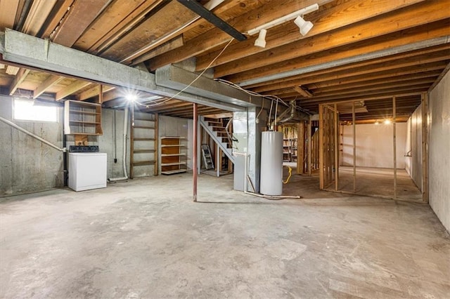 basement featuring washer / clothes dryer, gas water heater, and stairway
