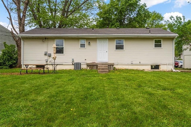 back of house featuring cooling unit and a yard