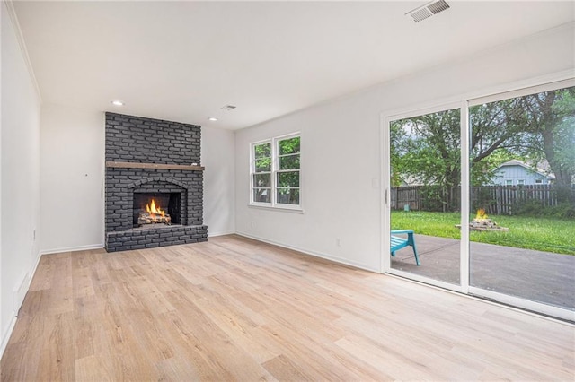 1912 E 153rd Ter, Olathe, KS 66062 - unfurnished living room with wood finished floors, baseboards, a fireplace, and recessed lighting