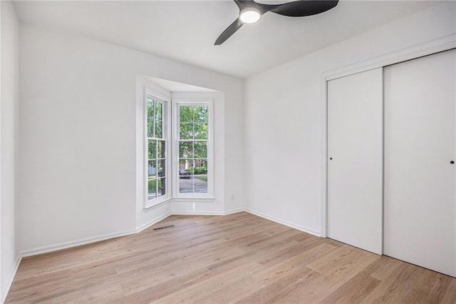 1912 E 153rd Ter, Olathe, KS 66062 - unfurnished bedroom featuring wood finished floors, a closet, a ceiling fan, and baseboards