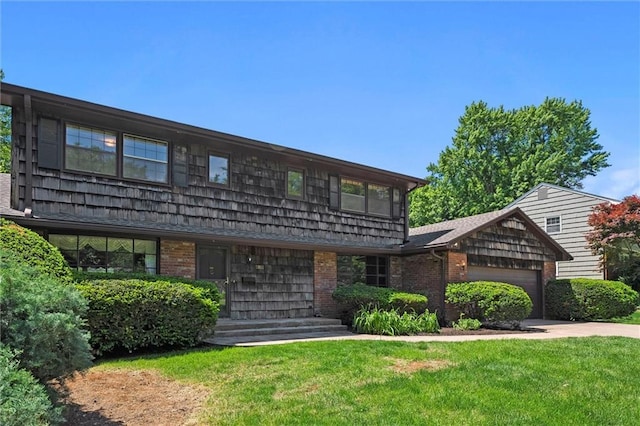 5811 W 85th Ter, Overland Park, KS 66207 - view of front facade with an attached garage, a front lawn, concrete driveway, and brick siding