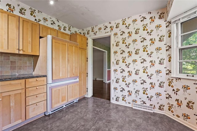 5811 W 85th Ter, Overland Park, KS 66207 - kitchen with wallpapered walls, baseboards, decorative backsplash, and dark stone counters
