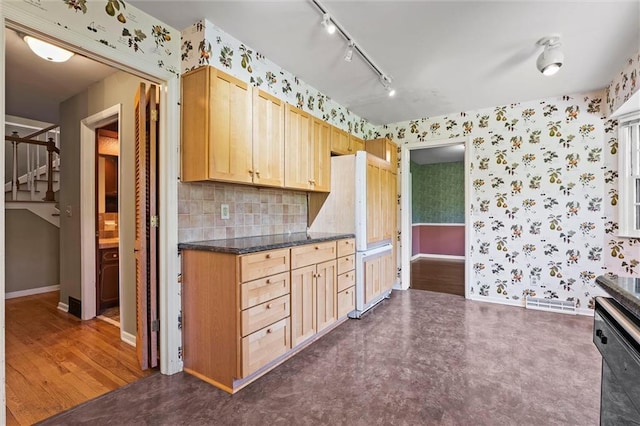 5811 W 85th Ter, Overland Park, KS 66207 - kitchen featuring wallpapered walls, track lighting, dark countertops, dishwasher, and baseboards