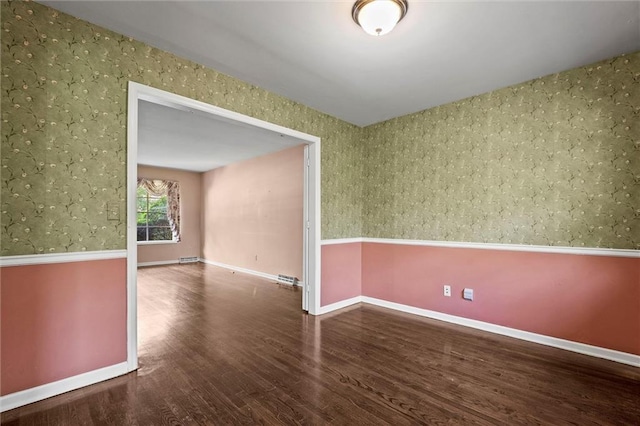 5811 W 85th Ter, Overland Park, KS 66207 - unfurnished room with wallpapered walls, wood finished floors, and baseboards