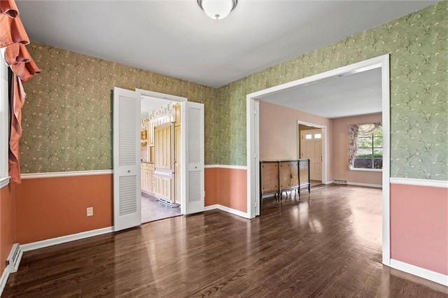 5811 W 85th Ter, Overland Park, KS 66207 - unfurnished room with wallpapered walls, wood finished floors, baseboard heating, and baseboards