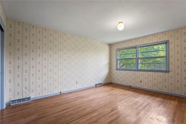 5811 W 85th Ter, Overland Park, KS 66207 - unfurnished room featuring wood finished floors and wallpapered walls