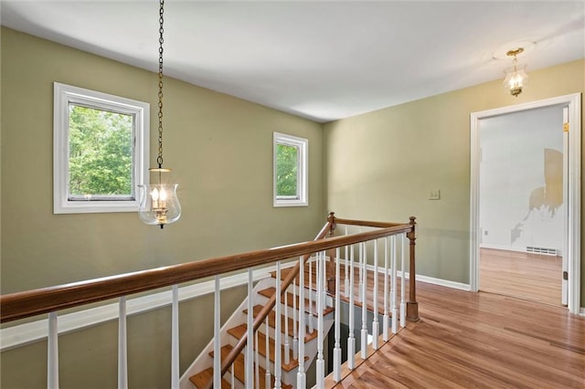 5811 W 85th Ter, Overland Park, KS 66207 - hall with an upstairs landing, wood finished floors, and baseboards