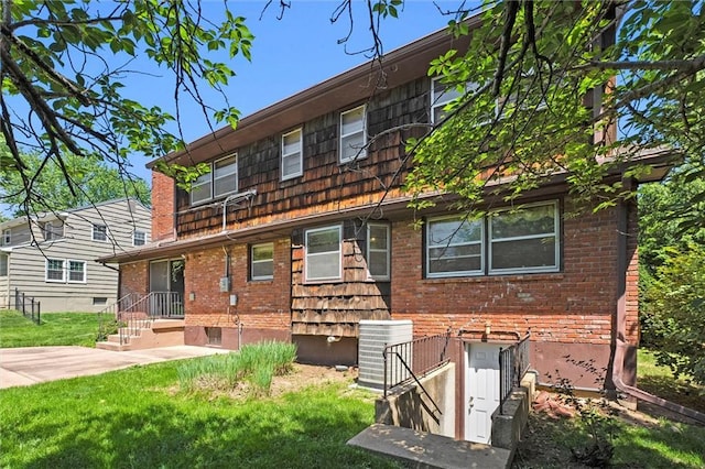 5811 W 85th Ter, Overland Park, KS 66207 - view of front of house featuring cooling unit, brick siding, and a front yard