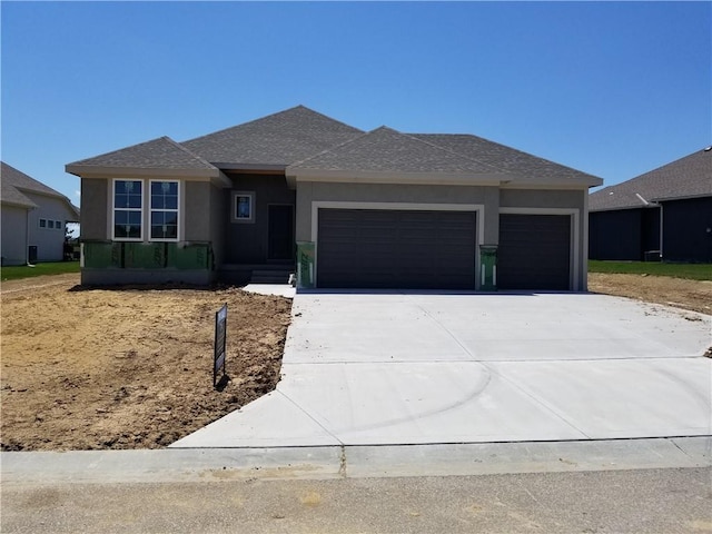14463 Aurora Ln, Basehor, KS 66007 - prairie-style home with an attached garage, concrete driveway, stucco siding, and roof with shingles