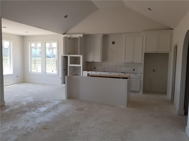 14463 Aurora Ln, Basehor, KS 66007 - kitchen with a center island, lofted ceiling, and white cabinets
