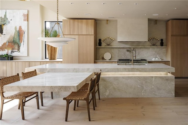 dining area with recessed lighting and light wood finished floors