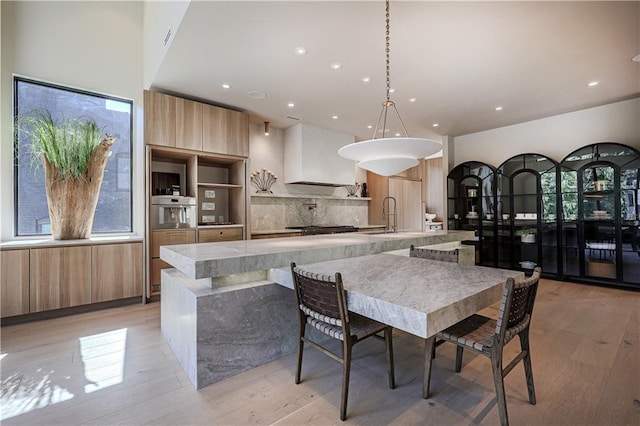 dining room featuring light wood finished floors and recessed lighting