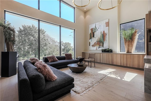 living room with light wood finished floors and a high ceiling