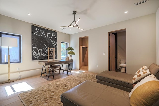 living area with wood finished floors and recessed lighting