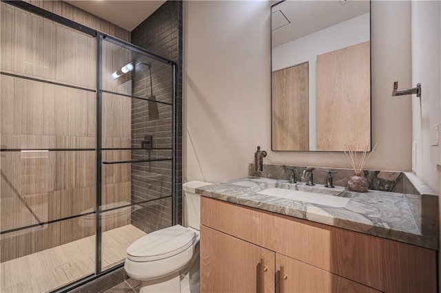 full bath with toilet, a stall shower, and vanity