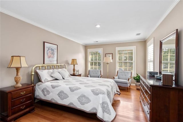 bedroom featuring wood finished floors, crown molding, recessed lighting, and baseboards