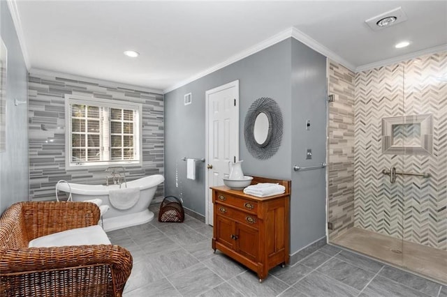 full bathroom featuring a stall shower, a freestanding tub, ornamental molding, tile patterned flooring, and baseboards