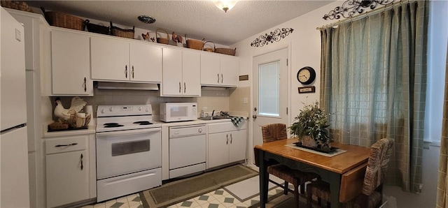4006 W 63rd St, Prairie Village, KS 66208 - kitchen with white appliances, under cabinet range hood, a textured ceiling, and white cabinets