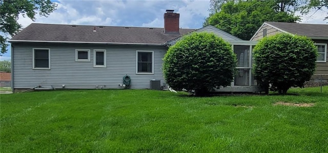 4006 W 63rd St, Prairie Village, KS 66208 - back of property featuring a chimney, a yard, cooling unit, and a shingled roof
