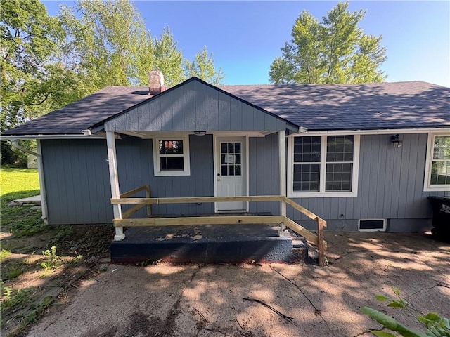 710 N Willis Ave, Independence, MO 64050 - view of front of house with a shingled roof, a chimney, and covered porch