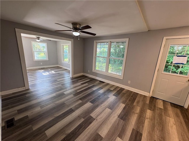 710 N Willis Ave, Independence, MO 64050 - unfurnished room with baseboards, dark wood-type flooring, and ceiling fan